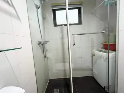 a bathroom with a shower and a toilet and a window at KL Tower Makati near AIM, Greenbelt 90mbps WIFI in Manila