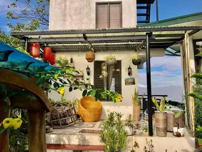 a house with a bunch of plants in front of it at Dicimulacion Staycation House in Angono