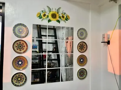 a wall with many plates on a wall at Dicimulacion Staycation House in Angono