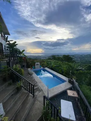 a swimming pool sitting on top of a house at Dicimulacion Staycation House in Angono