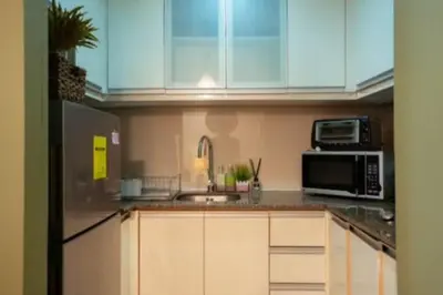a kitchen with a sink and a microwave at Cozy Studio Flat Near Airport in Manila