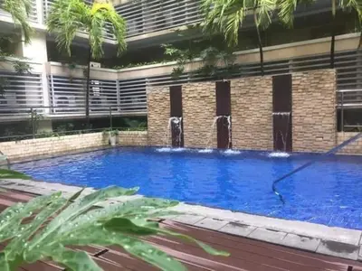 a large blue swimming pool in front of a building at Pasay Staycation with Parking Space in 150 Newport Boulevard near Resort World & NAIA T3 in Manila