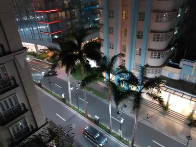 a view of a city street with palm trees and buildings at Pasay Staycation with Parking Space in 150 Newport Boulevard near Resort World & NAIA T3 in Manila