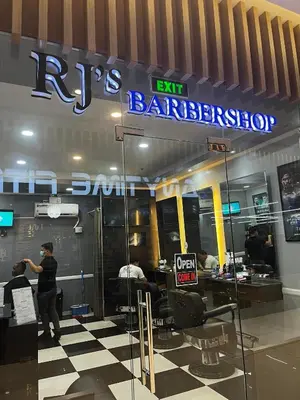 a person standing in front of a barber shop at Comfy Condo near BGC, Makati and Naia in Manila