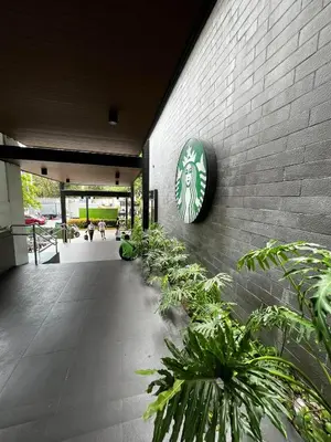 a brick wall with a clock on the side of a building at Comfy Condo near BGC, Makati and Naia in Manila