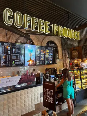 a woman standing at the counter of a coffee truck at Comfy Condo near BGC, Makati and Naia in Manila