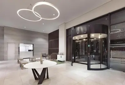 a lobby with a table and chairs and a chandelier at Hotel101 - Fort in Manila