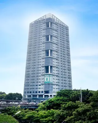 a tall white building with a sign on it at Hotel101 - Fort in Manila