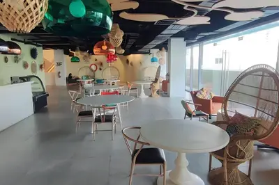 a dining room with tables and chairs and windows at Aveline Suites Cozy Skyline View ACQUA Private Residences near Rockwell Makati in Manila