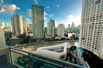 a view of a city skyline from a balcony at Aveline Suites Cozy Skyline View ACQUA Private Residences near Rockwell Makati in Manila
