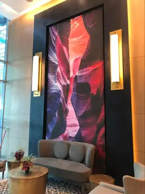 a lobby with a couch and a large painting on the wall at Aveline Suites Cozy Skyline View ACQUA Private Residences near Rockwell Makati in Manila