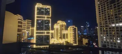 a view of a city at night with lights at Aveline Suites Executive City View ACQUA Private Residences near Rockwell Makati in Manila