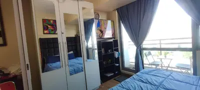 a bedroom with a bed and a large mirror at Aveline Suites Executive City View ACQUA Private Residences near Rockwell Makati in Manila