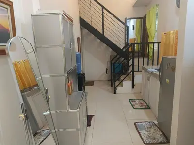a kitchen with a refrigerator and a staircase at Misty Hills Guesthouse Amadeo - Tagaytay in Amadeo