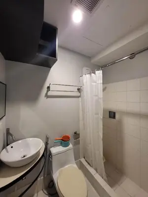 a bathroom with a toilet and a sink at Loft Suite in Chateau Elysee near Airport in Manila