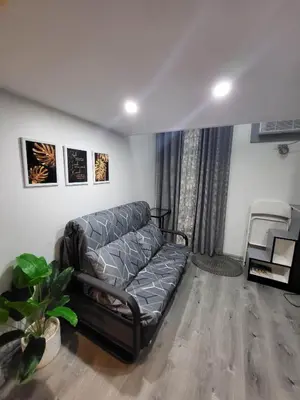 a living room with a couch and a chair at Loft Suite in Chateau Elysee near Airport in Manila