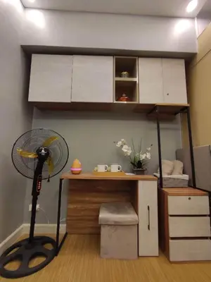 a home office with a desk and a fan at Maicozy condo in Manila
