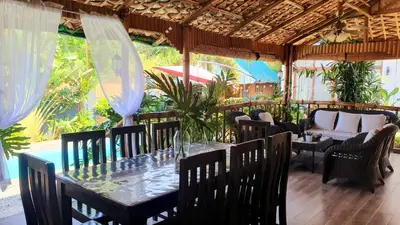 a dining room with a table and chairs at The Farm Shack by SMS Hospitality in Amadeo