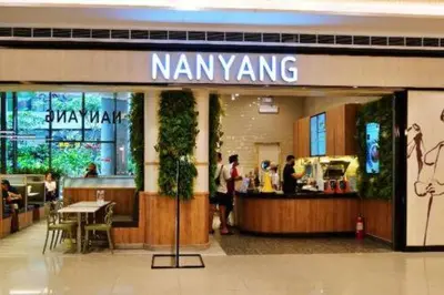 a nanyang store in a shopping mall with people in it at Cozy Crib @ Air Residences - Makati in Manila