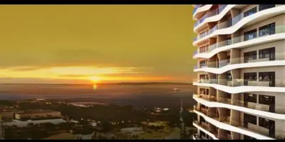 a view of a building with the sunset in the background at Coast Residences Penthouse with skyline and manila bay view in Manila