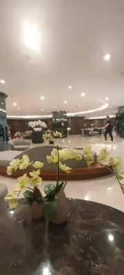a bunch of yellow flowers in vases in a lobby at Shore 3 Residences MOA Manila in Manila