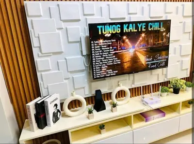 a tv on a wall in a room at Shore 3 Residences MOA Manila in Manila