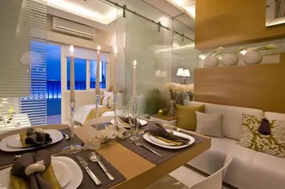 a dining room with a table with plates of food at Shore 3 Residences MOA Manila in Manila