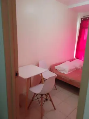 a small room with a table and a bed at URBAN DECA O1257 Ortigas near SM EAST PASIG in Manila
