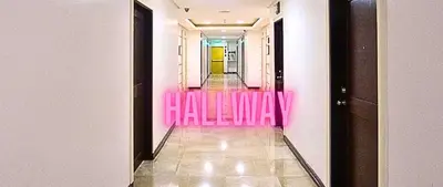 a hallway with pink walls at Family Room Affordable, Cheapest Deluxe Double Unit in Manila with 2 Balconies & 2 Bathrooms 25 Percent Discount, Free Sauna & Pool Access Near Manila Bay, Robinsons Place Ermita, Pgh, Bellagio, UP, Pedrogil, US Embassy, NAIA Airport Updated 2024 in Manila