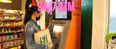 a woman is putting a box into an atm machine at Family Room Affordable, Cheapest Deluxe Double Unit in Manila with 2 Balconies & 2 Bathrooms 25 Percent Discount, Free Sauna & Pool Access Near Manila Bay, Robinsons Place Ermita, Pgh, Bellagio, UP, Pedrogil, US Embassy, NAIA Airport Updated 2024 in Manila