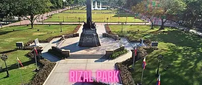 a large monument in a park with a sign that reads real park at Family Room Affordable, Cheapest Deluxe Double Unit in Manila with 2 Balconies & 2 Bathrooms 25 Percent Discount, Free Sauna & Pool Access Near Manila Bay, Robinsons Place Ermita, Pgh, Bellagio, UP, Pedrogil, US Embassy, NAIA Airport Updated 2024 in Manila
