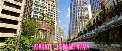 a city street with tall buildings and a pink sign at Family Room Affordable, Cheapest Deluxe Double Unit in Manila with 2 Balconies & 2 Bathrooms 25 Percent Discount, Free Sauna & Pool Access Near Manila Bay, Robinsons Place Ermita, Pgh, Bellagio, UP, Pedrogil, US Embassy, NAIA Airport Updated 2024 in Manila
