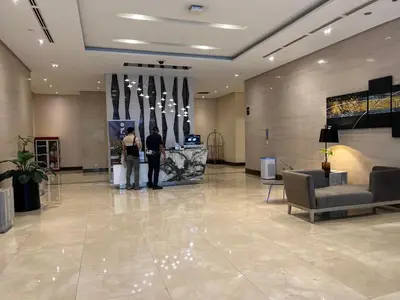 two people standing in a lobby of a building at Condotel in Venice Grand Canal Mall Taguig in Manila