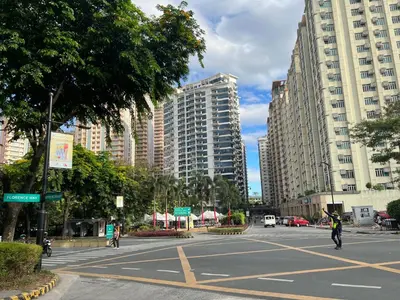 an empty street in a city with tall buildings at Condotel in Venice Grand Canal Mall Taguig in Manila