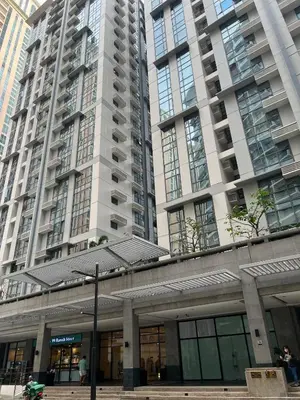 a large building with tall buildings in the background at Condotel in Venice Grand Canal Mall Taguig in Manila