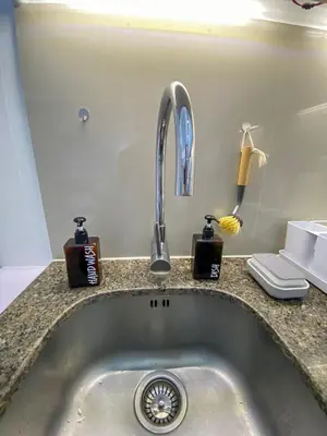 a kitchen sink with a faucet and complimentary soap at nJoy! BOHO Luxury at Venice Grand Canal in Manila