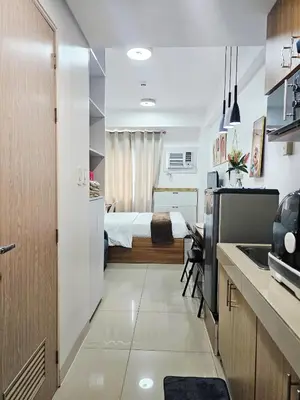 a small room with a bed and a kitchen at Acellyne's Suites at Green 2 Residences with Netflix! in Dasmariñas