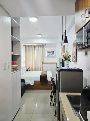 a small room with a bed and a kitchen at Acellyne's Suites at Green 2 Residences with Netflix! in Dasmariñas