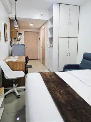 a bedroom with a bed and a desk and a computer at Acellyne's Suites at Green 2 Residences with Netflix! in Dasmariñas