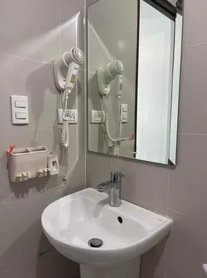 a bathroom with a white sink and a mirror at Cubao Manhattan, U 8J T D,Studio in Manila