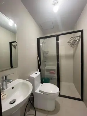 a bathroom with a toilet and a sink and a shower at Cubao Manhattan, U 8J T D,Studio in Manila