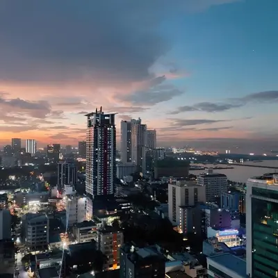 a view of a city skyline at night at BirchTower Studio Condo with Balcony & Pool - Carosa Staycation in Manila
