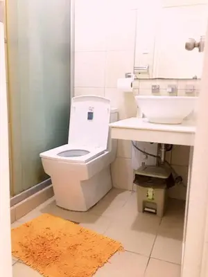 a bathroom with a toilet and a sink at BirchTower Studio Condo with Balcony & Pool - Carosa Staycation in Manila