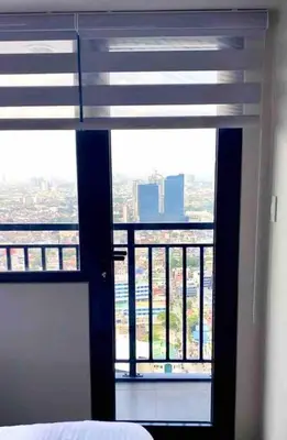 a bedroom with a window with a view of the city at Scandinavian Studio in Makati in Manila