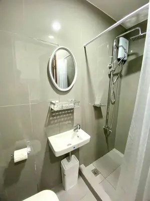 a white bathroom with a sink and a mirror at Scandinavian Studio in Makati in Manila