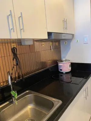 a kitchen with a sink and a counter top at Coast Stay by J 40th floor Penthouse in Manila