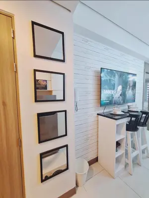 a room with a desk and a tv on a wall at Coast Stay by J 40th floor Penthouse in Manila