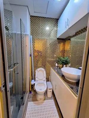 a bathroom with a toilet and a sink at Coast Stay by J 40th floor Penthouse in Manila