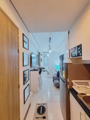 a room with a kitchen and a living room at Coast Stay by J 40th floor Penthouse in Manila