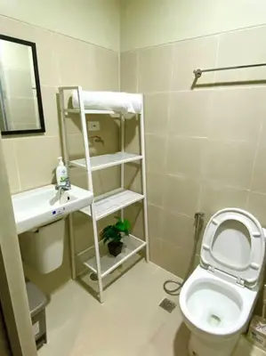 a small bathroom with a toilet and a sink at Modern 1-BR Condo Unit in Manila